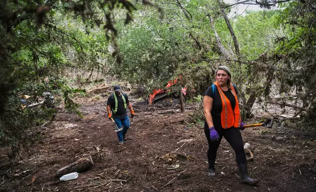 Volunteers carry out search and rescue operations near the Guadalupe River after a flash flood swept through the area Monday, July 7, 2025, in Ingram, Texas. (AP Photo/Eli Hartman)