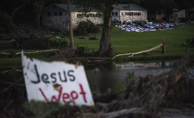 Camper's belongings sit outside one of Camp Mystic's cabins near the Guadalupe River after a flash flood swept through the area Monday, July 7, 2025, in Hunt, Texas. (AP Photo/Eli Hartman)