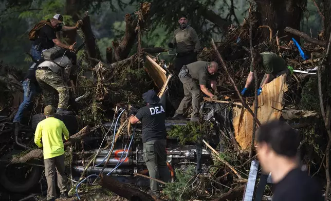 First responders carry out search and rescue operations near the Guadalupe River after a flash flood swept through the area Monday, July 7, 2025, in Ingram, Texas. (AP Photo/Eli Hartman)