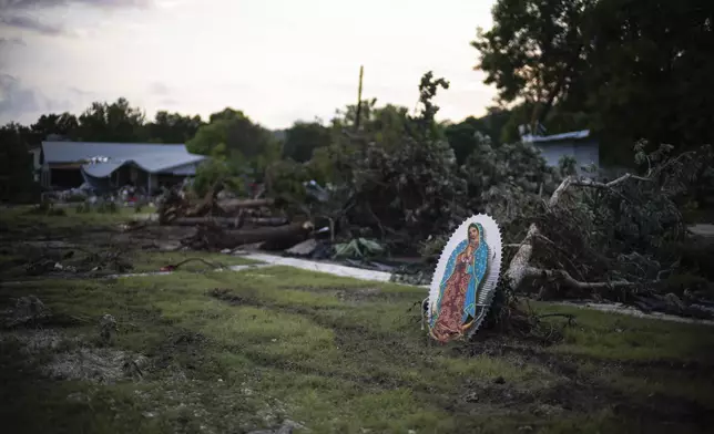 An Virgin of Guadalupe icon is seen amongst the damaged property of a home in Hunt, Texas, near the Guadalupe River, Monday, July 7, 2025, after a flash flood swept through the area. (AP Photo/Eli Hartman)