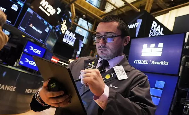 Trader Drew Cohen works on the floor of the New York Stock Exchange, Tuesday, July 1, 2025. (AP Photo/Richard Drew)