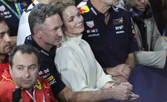 FILE -Red Bull team principal Christian Horner is flanked by his wife Geri Alliwell after the Formula One Saudi Arabian Grand Prix at the Jeddah Corniche Circuit, in Jedda, Saudi Arabia, March 9, 2024. (AP Photo/Giuseppe Cacace/Pool, File)