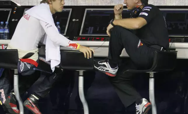 FILE - Red Bull Formula One driver Sebastian Vettel, left, of Germany talks with team principal Christian Horner on pit wall following the first practice session for the Singapore Grand Prix on the Marina Bay City Circuit in Singapore, Sept. 24, 2010. (AP Photo/Ng Han Guan, File)