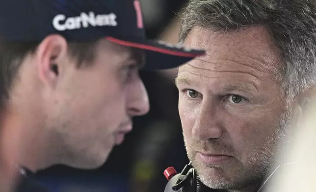 FILE - Red Bull team principal Christian Horner, right, talks to Red Bull driver Max Verstappen of the Netherlands before the qualifying session ahead of Sunday's Formula One Italian Grand Prix auto race, at the Monza racetrack, in Monza, Italy, Sept. 2, 2023. (Christian Bruna/Pool via AP File)