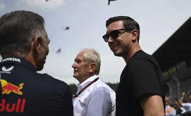 FILE - Red Bull owner Mark Dietrich Mateschitz, center, stands with team members Helmut Marko, center, and team principal Christian Horner in the paddock ahead of the Austrian Formula One Grand Prix race at the Red Bull Ring racetrack in Spielberg, Austria, June 30, 2024. (AP Photo/Christian Bruna, File)