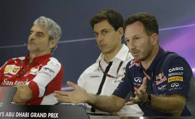 FILE - Flanked by Mercedes team principal Toto Wolff, center and Ferrari team principal Maurizio Arrivabene, left, Red Bull team principal Christian Horner speaks at a news conference at the Yas Marina racetrack in Abu Dhabi, United Arab Emirates, Nov. 27, 2015. (AP Photo/Luca Bruno, File)