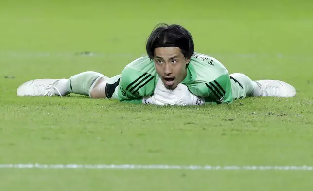 Vancouver Whitecaps goalkeeper Yohei Takaoka reacts after trapping the ball on a shot on goal by the Houston Dynamo during the second half of an MLS soccer match, Wednesday, July 16, 2025, in Houston. (AP Photo/Michael Wyke)