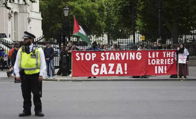People take part in a protest outside Downing Street in London, Tuesday July 29, 2025, as Prime Minister Keir Starmer gathered senior ministers for an urgent Cabinet meeting on Gaza. (Jonathan Brady/PA via AP)