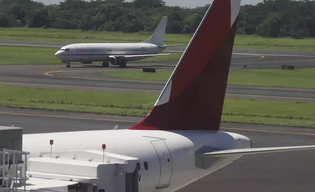 An aircraft with a Venezuelan flag taxis on the runway to another area of the Oscar Arnulfo Romero International Airport in San Luis Talpa, El Salvador, Friday, July 18, 2025. (AP Photo/Salvador Melendez)
