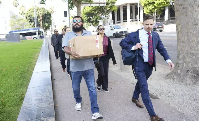 From left, Felix Rubio, Kim Rubio and attorney Josh Koskoff arrive for a court hearing in a lawsuit between victims' families in the 2022 Uvalde, Texas school shooting and Meta Platforms on Friday, July 18, 2025, in Los Angeles. (AP Photo/Eric Thayer)