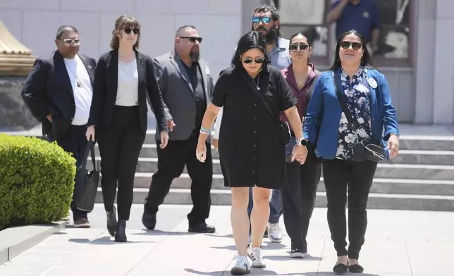 Gloria Cazares, right, holds hands with Veronica Mata during a break in a court hearing in a lawsuit between victims' families in the 2022 Uvalde, Texas school shooting and Meta Platforms on Friday, July 18, 2025, in Los Angeles. (AP Photo/Eric Thayer)