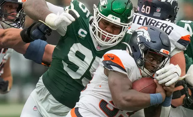FILE - New York Jets defensive tackle Quinnen Williams (95) tackles Denver Broncos running back Javonte Williams (33) during the fourth quarter of an NFL football game, Sunday, Sept. 29, 2024, in East Rutherford, N.J. (AP Photo/Seth Wenig, File)