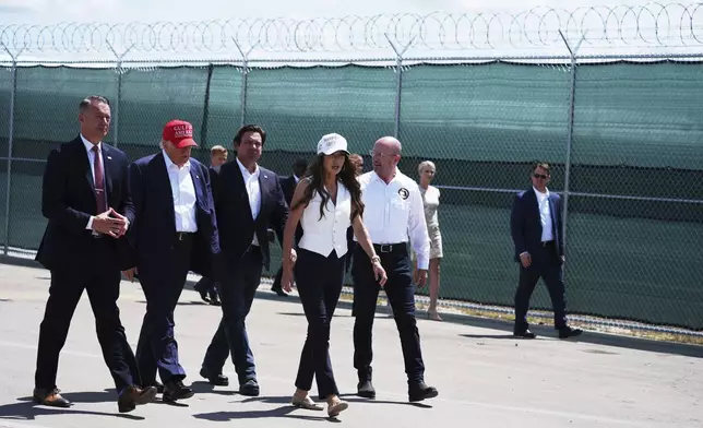 President Donald Trump, Gov. Ron DeSantis, R-Fla., and Homeland Security Secretary Kristi Noem, and others, tour "Alligator Alcatraz," a new migrant detention facility at Dade-Collier Training and Transition facility, Tuesday, July 1, 2025, in Ochopee, Fla. (AP Photo/Evan Vucci)