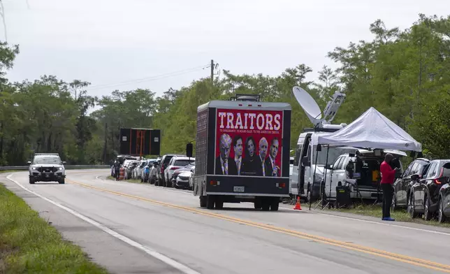 A truck drives past the Dade-Collier Training and Transition Airport where President Donald Trump appeared, Tuesday, July 1, 2025, in Ochopee, Fla. (AP Photo/Michael Laughlin)