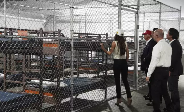 President Donald Trump, Gov. Ron DeSantis, R-Fla., and Homeland Security Secretary Kristi Noem, and others, tour "Alligator Alcatraz," a new migrant detention facility at Dade-Collier Training and Transition facility, Tuesday, July 1, 2025, in Ochopee, Fla. (AP Photo/Evan Vucci)