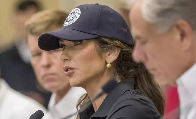 Homeland Security Secretary Kristi Noem, center, and Texas Gov. Greg Abbott, right, discuss the ongoing search and rescue efforts after recent flooding along the Guadalupe River during a press conference on Saturday, July 5, 2025, in Kerrville, Texas. (AP Photo/Rodolfo Gonzalez)