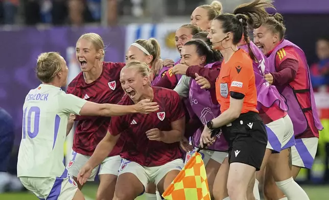 Wales' Jess Fishlock celebrates with teammates after scoring her sides first goal during the Euro 2025, group D, soccer match between France and Wales at Arena St. Gallen in St. Gallen, Switzerland, Wednesday, July 9, 2025. (AP Photo/Martin Meissner)
