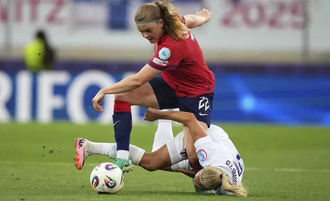 Norway's Signe Gaupset fights for the ball with Finland 's Emma Koivisto, on the ground, during the Euro 2025, group A, soccer match between Norway and Finland at Stade de Tourbillon in Sion, Switzerland, Sunday, July 6, 2025. (AP Photo/Alessandra Tarantino)