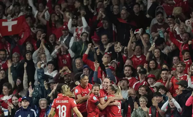 Switzerland's Geraldine Reuteler celebrates with team mates after scoring the opening goal during the Euro 2025, group A, soccer match between Switzerland and Iceland at Stadion Wankdorf in Bern, Switzerland, Sunday, July 6, 2025. (AP Photo/Martin Meissner)