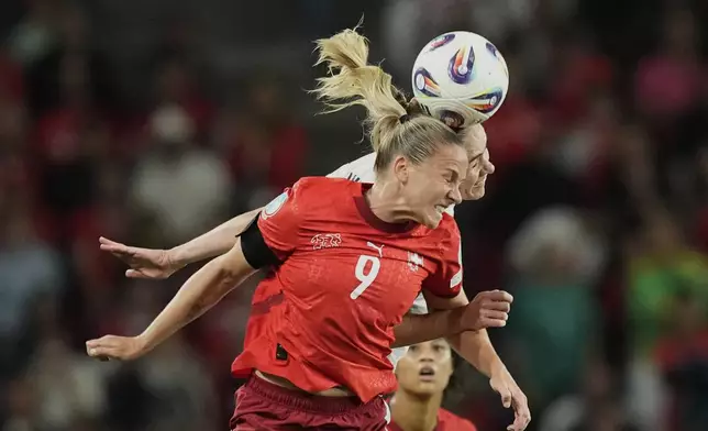 Switzerland's Ana-Maria Crnogorcevic, foreground, and Iceland's Dagny Brynjarsdottir challenge for the ball during the Euro 2025, group A, soccer match between Switzerland and Iceland at Stadion Wankdorf in Bern, Switzerland, Sunday, July 6, 2025. (AP Photo/Martin Meissner)