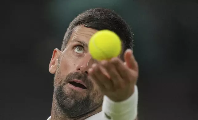 Novak Djokovic of Serbia serves to Alexandre Muller of France during their first round men's singles match at the Wimbledon Tennis Championships in London, Tuesday, July 1, 2025. (AP Photo/Kin Cheung)