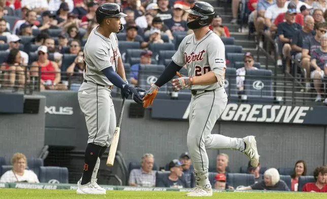Detroit Tigers' Spencer Torkelson, right, is congratulated by Wenceel Perez, left, after hitting a solo home run off Cleveland Guardians starting pitcher Logan Allen during the second inning of a baseball game, Saturday, July 5, 2025, in Cleveland. (AP Photo/Phil Long)