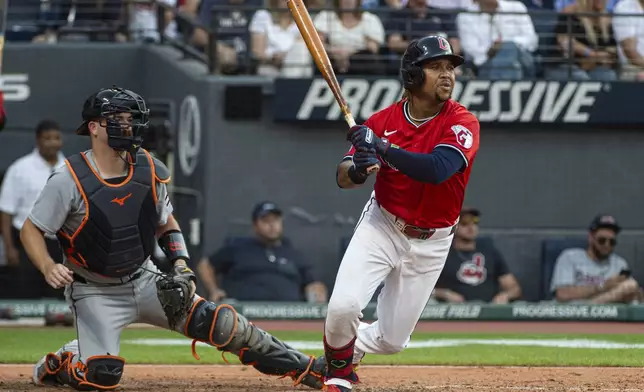 Cleveland Guardians' Jose Ramirez, right, watches his single off Detroit Tigers starting pitcher Casey Mize along with catcher Jake Rogers, left, during the fourth inning of a baseball game, Saturday, July 5, 2025, in Cleveland. (AP Photo/Phil Long)