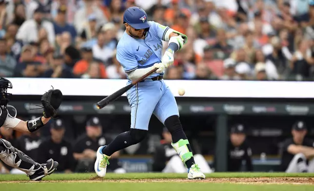 Toronto Blue Jays' Bo Bichette singles during the eighth inning of a baseball game against the Detroit Tigers, Saturday, July 26, 2025, in Detroit. (AP Photo/Jose Juarez)