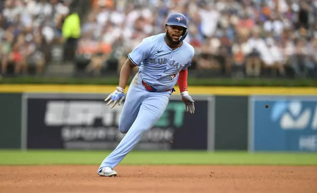 Toronto Blue Jays' Vladimir Guerrero Jr. runs to third base after a double by Bo Bichette during the fourth inning of a baseball game against the Detroit Tigers, Saturday, July 26, 2025, in Detroit. (AP Photo/Jose Juarez)