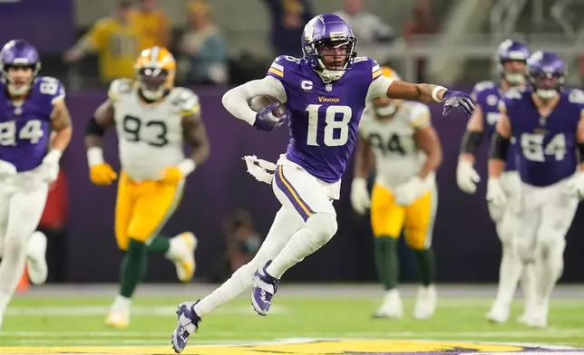 FILE - Minnesota Vikings' Justin Jefferson catches a pass for a first down during the second half of an NFL football game against the Green Bay Packers Sunday, Dec. 29, 2024, in Minneapolis. (AP Photo/Abbie Parr, File)