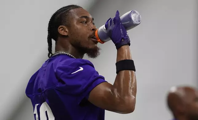 Minnesota Vikings wide receiver Justin Jefferson (18) hydrates during the team's NFL football training camp Wednesday, July 23, 2025, in Eagan, Minn. (AP Photo/Abbie Parr)