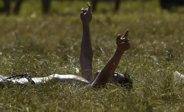 A young wrestler celebrates his victory in a round during the 664th annual Historic Kirkpinar Oil Wrestling championship, in Edirne, northwestern Turkey, Sunday, July 6, 2025.(AP Photo/Khalil Hamra)