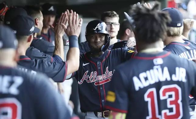 Atlanta Braves' Jurickson Profar celebrates with his teammates after hitting a two-run home run during the third inning of a baseball game against the Athletics, Thursday, July 10, 2025, in West Sacramento, Calif. (AP Photo/Scott Marshall)