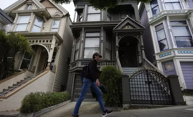 A man walks past the house where the original members of the Grateful Dead music group lived in San Francisco, Saturday, July 19, 2025. (AP Photo/Godofredo A. Vasquez)