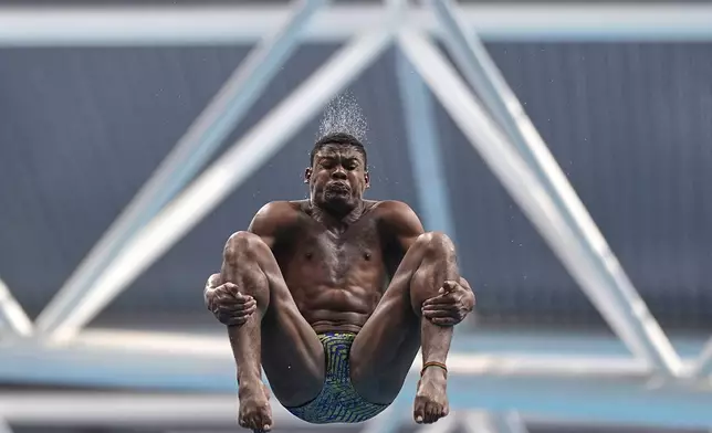 Luis Felipe Bonfim Dos Santos Moura of Brazil competes in the mixed 3m and 10m team diving final at the World Aquatics Championships in Singapore, Saturday, July 26, 2025. (AP Photo/Ng Han Guan)