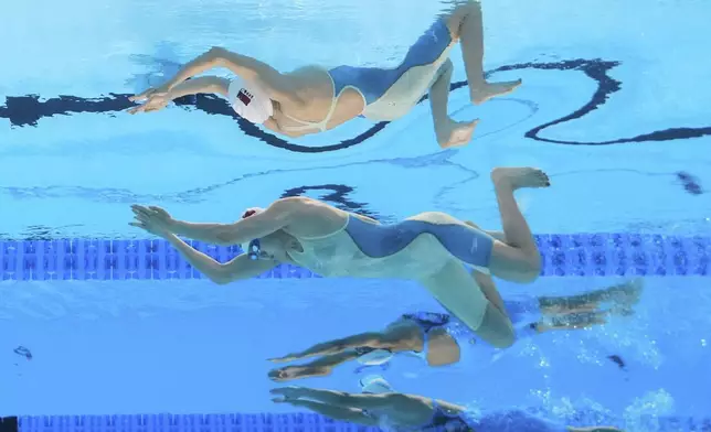 Tang Qianting of China and Neutral Athlete Belarus, Alina Zmushka compete in the women's 100m breaststroke Final at the World Aquatics Championships in Singapore, Tuesday, July 29, 2025. (AP Photo/Lee Jin-man)