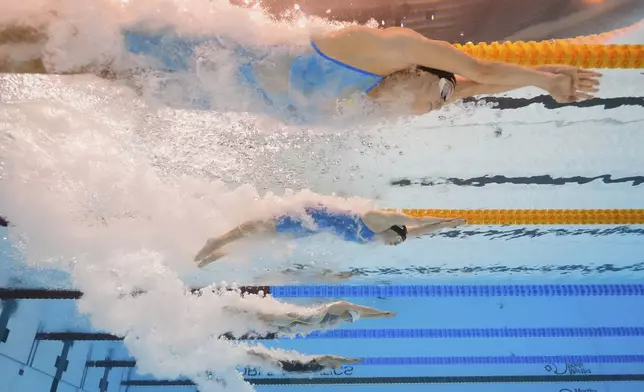 Gretchen Walsh of the United States, top, and Roos Vanotterdijk of Belgium, second from top, compete in the women's 100-meter butterfly semifinal at the World Aquatics Championships in Singapore, Sunday, July 27, 2025. (AP Photo/Lee Jin-man)