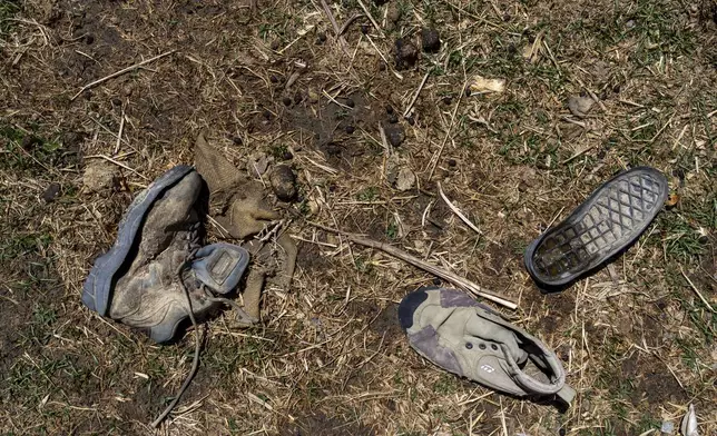 Worn out shoes are strewn in a field in the abandoned Samjung village, Mustang region, 462 kilometers (288 miles) west of Kathmandu, Nepal, Friday, April 18, 2025. (AP Photo/Niranjan Shrestha)
