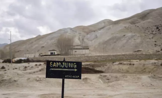 A signboard points the way to the newly relocated settlement of the abandoned Samjung village in the Mustang region, 462 kilometers (288 miles) west of Kathmandu, Nepal, Saturday, April 19, 2025. (AP Photo/Niranjan Shrestha)