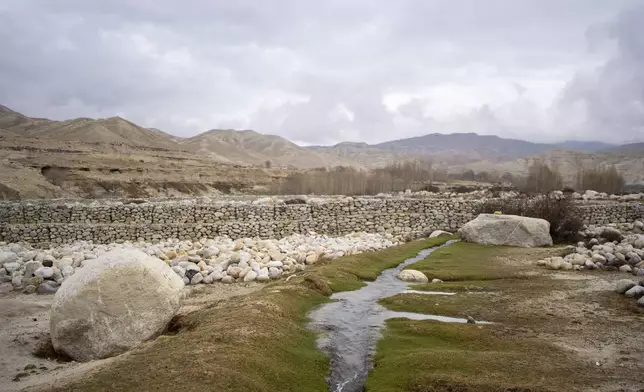 A stream which is the main source of drinking water flows through the newly relocated settlement of the abandoned Samjung village in the Mustang region, 462 kilometers west of Kathmandu, Nepal, Saturday, April 19, 2025. (AP Photo/Niranjan Shrestha)