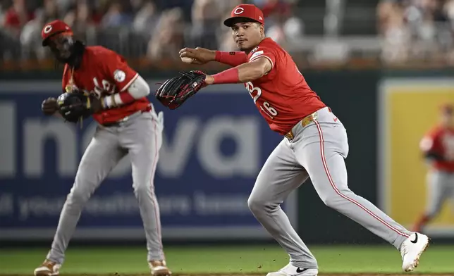 Cincinnati Reds third baseman Noelvi Marte, right, throws to first base for an out on a ball hit by Washington Nationals' Nathaniel Lowe off Reds pitcher Sam Moll during the sixth inning of a baseball game in Washington, Monday, July 21, 2025. (AP Photo/Terrance Williams)