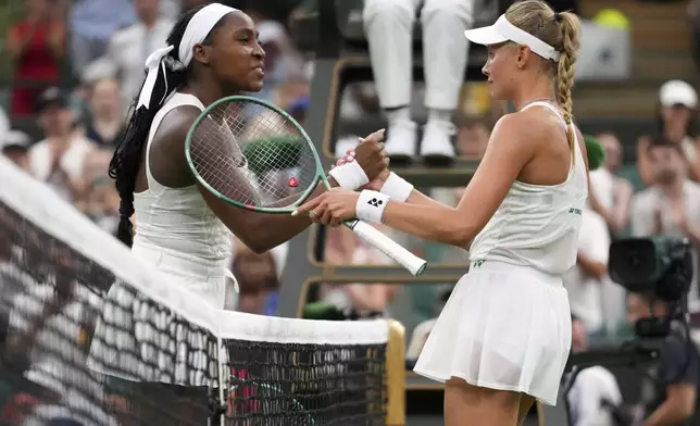 Dayana Yastremska of Ukraine shakes hands with Coco Gauff of the U.S., left, after winning the first round women's single match at the Wimbledon Tennis Championships in London, Tuesday, July 1, 2025.(AP Photo/Kirsty Wigglesworth)
