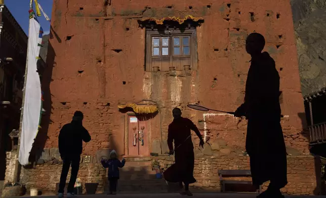 Monks play badminton in front of a monastery at Kagbeni, Mustang region, 462 kilometers (288 miles) west of Kathmandu, Nepal, Thursday, April 17, 2025. (AP Photo/Niranjan Shrestha)