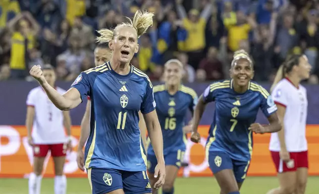 Sweden's Emma Blackstenius, left, celebrates after scoring the opening goal during the Euro 2025, group C, soccer match between Sweden and Poland in Lucerne, Switzerland, Tuesday, July 8, 2025. (Urs Flueeler/Keystone via AP)