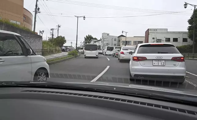 Vehicles evacuate to a highter ground in Kushiro, Hokkaido, northern Japan Wednesday, July 30, 2025, after a powerful earthquake in Russia's Far East prompted tsunami warnings in parts of Japan. (Kyodo News via AP)