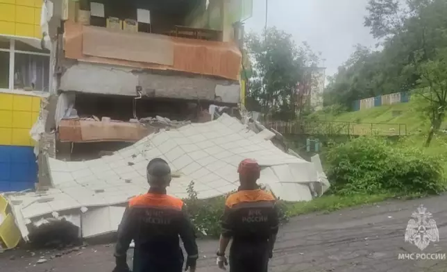 In this image taken from a video released by Russian Emergency Ministry Press Service, rescuers inspect a kindergarten damaged by an earthquake in Petropavlovsk-Kamchatsky, Russia, Wednesday, July 30, 2025. (Russian Emergency Ministry Press Service via AP)