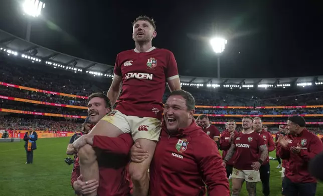 Hugo Keenan of the British &amp; Irish Lions, who scored the winning try is carried shoulder high by teammates after the second rugby union test against Australia at the Melbourne Cricket Ground in Melbourne, Australia, Saturday, July 26, 2025. (AP Photo/Asanka Brendon Ratnayake)