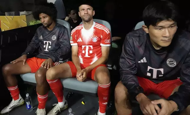 Bayern Munich's Serge Gnabry, from left, Thomas Muller, and Kim Min-jae sit on the bench during the Club World Cup quarterfinal soccer match between PSG and Bayern Munich in Atlanta, Saturday, July 5, 2025. (AP Photo/Mike Stewart)