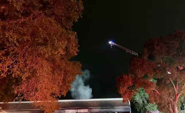 This photo provided by the San Jose Fire Department shows firefighters responding to a fire burning after a car crashed into a Post Office, early Sunday, July 20, 2025, in San Jose, Calif. (San Jose Fire Department via AP)