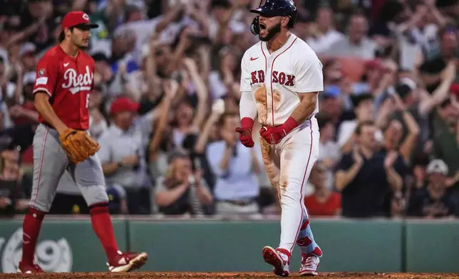 Boston Red Sox's Wilyer Abreu, right, celebrates after his inside-the-park home run off Cincinnati Reds pitcher Joe LaSorsa, left, during the fifth inning of a baseball game at Fenway Park, Monday, June 30, 2025, in Boston. (AP Photo/Charles Krupa)